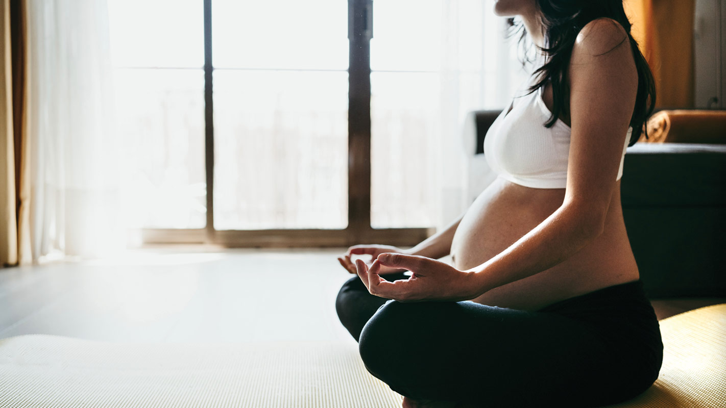 Pregnant woman calm and meditating.